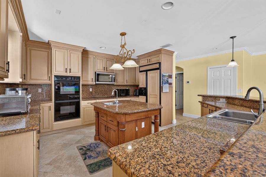 Chef's kitchen with island and pendant lights