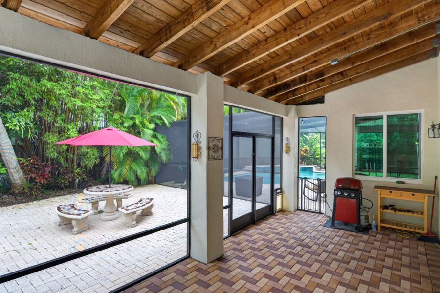 Wood beamed lanai opening to the garden
